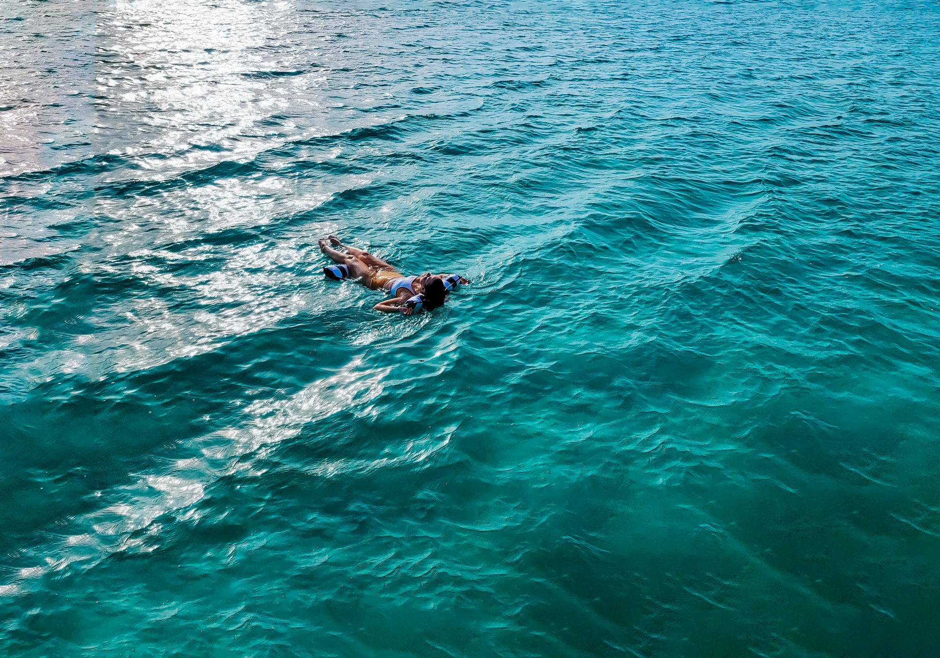Cyan Stone floating on bright turquoise water